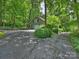 Charming home with attached garage, surrounded by lush greenery and a well-maintained driveway at 3040 Valencia Ter, Charlotte, NC 28211
