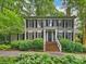 Charming two-story home with a brick stairway, complemented by lush landscaping and a welcoming facade at 3040 Valencia Ter, Charlotte, NC 28211