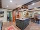 Open-concept kitchen with brick floor, wooden cabinetry, large island and seamless flow to dining area at 3040 Valencia Ter, Charlotte, NC 28211