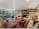 Cozy living room featuring a brick fireplace, comfortable seating, and seamless flow to adjacent rooms at 3040 Valencia Ter, Charlotte, NC 28211
