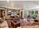 Spacious living room with hardwood floors, built-in bookshelves, and multiple seating areas at 3040 Valencia Ter, Charlotte, NC 28211