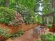 Charming patio with brick pavers, lush landscaping, and outdoor seating at 3040 Valencia Ter, Charlotte, NC 28211