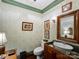 Charming powder room featuring wallpaper, wood trim, and unique sink at 3040 Valencia Ter, Charlotte, NC 28211