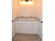 This bathroom features a double vanity with granite countertop and white cabinets with gold pulls at 307 N Catawba St, Lancaster, SC 29720