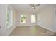 This bedroom features hardwood floors and three windows overlooking the front yard at 307 N Catawba St, Lancaster, SC 29720
