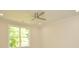 Bedroom with ceiling fan, window providing natural light and views of tree-lined street at 307 N Catawba St, Lancaster, SC 29720