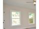 This bedroom features hardwood floors and two windows overlooking the backyard and a ceiling fan at 307 N Catawba St, Lancaster, SC 29720