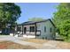 Newly renovated exterior with a black railed porch, crisp white siding and neutral concrete driveway at 307 N Catawba St, Lancaster, SC 29720