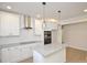 Bright, all-white kitchen featuring granite countertops, stainless appliances and central island at 307 N Catawba St, Lancaster, SC 29720