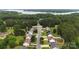 Aerial view of the property featuring a well-manicured lawn, mature trees, and proximity to Lake Norman at 311 Masters Dr, Rock Hill, SC 29732