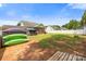 Expansive backyard featuring green lawn, trees, storage, and screened-in porch, ideal for outdoor living at 311 Masters Dr, Rock Hill, SC 29732