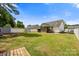 Large backyard with a privacy fence, storage shed, and mature trees, perfect for outdoor enjoyment at 311 Masters Dr, Rock Hill, SC 29732