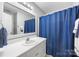 Bright bathroom with a vanity, sink, toilet and a shower/tub combo with a blue curtain at 311 Masters Dr, Rock Hill, SC 29732