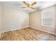 Bright bedroom with wood-look floors and a fan; bathed in natural light from a nearby window at 311 Masters Dr, Rock Hill, SC 29732