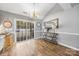 Bright dining area with hardwood floors, stylish lighting, and sliding glass doors leading to the outdoor deck at 311 Masters Dr, Rock Hill, SC 29732