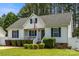 Charming single-Gathering home featuring a well-kept lawn, blue shutters, and a welcoming front porch with an American flag at 311 Masters Dr, Rock Hill, SC 29732