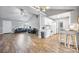 Open-concept living space featuring hardwood floors, a fireplace, and a view into the modern white kitchen at 311 Masters Dr, Rock Hill, SC 29732