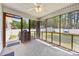 Relaxing screened-in porch with ceiling fan, overlooking a fenced backyard with mature trees and storage shed at 311 Masters Dr, Rock Hill, SC 29732