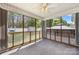 Relaxing screened-in porch featuring a ceiling fan and views of the spacious backyard with a shed and gazebo at 311 Masters Dr, Rock Hill, SC 29732