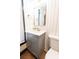 Bathroom featuring a grey vanity with gold fixtures and mirror at 3150 Driftwood Dr # B, Charlotte, NC 28205