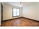 Bright bedroom with wood-look floors and ceiling fan at 3150 Driftwood Dr # B, Charlotte, NC 28205