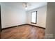 Bright bedroom with wood-look floors and ceiling fan at 3150 Driftwood Dr # B, Charlotte, NC 28205