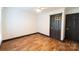 Bedroom with wood-look floors and dark trim at 3150 Driftwood Dr # B, Charlotte, NC 28205
