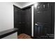 Hallway with dark doors and gold hardware, offering a stylish transition between rooms in the home at 3150 Driftwood Dr # B, Charlotte, NC 28205