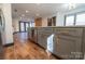 Modern kitchen with stainless appliances, gray cabinets with gold pulls, and hardwood flooring at 3150 Driftwood Dr # B, Charlotte, NC 28205
