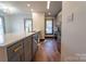 Modern kitchen with stainless appliances, gray cabinets, quartz counters, and gold hardware at 3150 Driftwood Dr # B, Charlotte, NC 28205