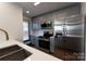 Well-equipped kitchen featuring stainless steel appliances, gray cabinetry, and modern finishes throughout at 3150 Driftwood Dr # B, Charlotte, NC 28205