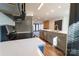 Modern kitchen boasts stainless steel appliances, gray cabinetry, and a spacious island, perfect for entertaining at 3150 Driftwood Dr # B, Charlotte, NC 28205