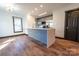 Modern kitchen with a large center island, gray cabinets, quartz counters, and stainless appliances at 3150 Driftwood Dr # B, Charlotte, NC 28205