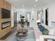 Bright living room with modern fireplace, open floor plan, dining area, and kitchen with large island at 3150 Driftwood Dr # B, Charlotte, NC 28205