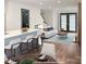 Bright living room with modern fireplace and open floor plan featuring hardwood floors and modern furnishings at 3150 Driftwood Dr # B, Charlotte, NC 28205