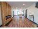 Spacious living area with hardwood floors, fireplace, and open-concept kitchen and dining area at 3150 Driftwood Dr # B, Charlotte, NC 28205
