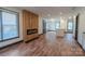 Spacious living area with hardwood floors, modern fireplace, and bright open-concept kitchen and dining at 3150 Driftwood Dr # B, Charlotte, NC 28205