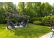Backyard with a wooden pergola and outdoor seating area at 3186 Helmsley Ct, Concord, NC 28027