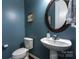 Charming powder room with pedestal sink, decorative mirror, and elegant blue wall color at 3186 Helmsley Ct, Concord, NC 28027