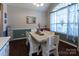 Charming dining area with modern table set, bright window, and stylish decor at 3186 Helmsley Ct, Concord, NC 28027