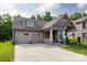 Charming home featuring a two-car garage, covered porch and a beautifully landscaped front yard at 3186 Helmsley Ct, Concord, NC 28027