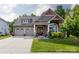 Charming home featuring a two-car garage, covered porch and a beautifully landscaped front yard at 3186 Helmsley Ct, Concord, NC 28027