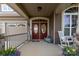 Inviting front porch with double doors, decor, and a charming rocking chair at 3186 Helmsley Ct, Concord, NC 28027