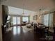 Inviting living room featuring a stone fireplace, vaulted ceiling, and an open layout to the dining area at 3186 Helmsley Ct, Concord, NC 28027