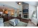 Open-concept living room with stone fireplace and seamless connection to dining and kitchen areas at 3186 Helmsley Ct, Concord, NC 28027