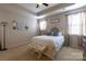 Cozy bedroom featuring a comfortable bed, tray ceiling, and soft natural lighting at 3186 Helmsley Ct, Concord, NC 28027