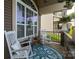 Cozy covered porch with rocking chairs, decorative pillows, and a stylish outdoor rug at 3186 Helmsley Ct, Concord, NC 28027