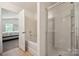 Bright bathroom features a tub and separate tiled shower with glass door, next to the bedroom at 3512 Gibbon Terrace Ct, Charlotte, NC 28269