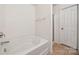 Bright bathroom featuring a bathtub and shower combo, and neutral-colored tiles at 3512 Gibbon Terrace Ct, Charlotte, NC 28269