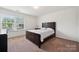 Bedroom with neutral carpet, a window with blinds, and a wood bed frame at 3512 Gibbon Terrace Ct, Charlotte, NC 28269